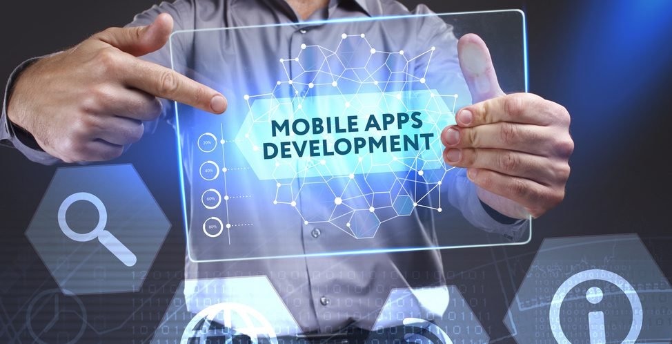 Developer holding a screen that reads Mobile Apps Development