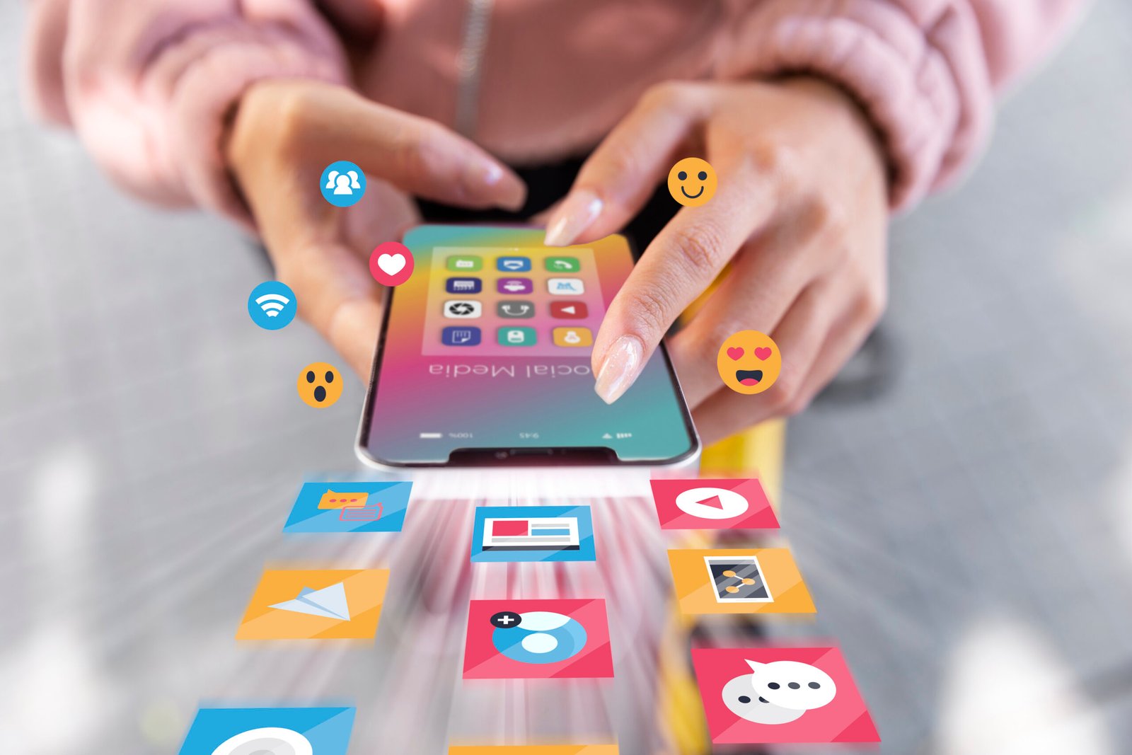 Hands using a phone surrounded by social media icons